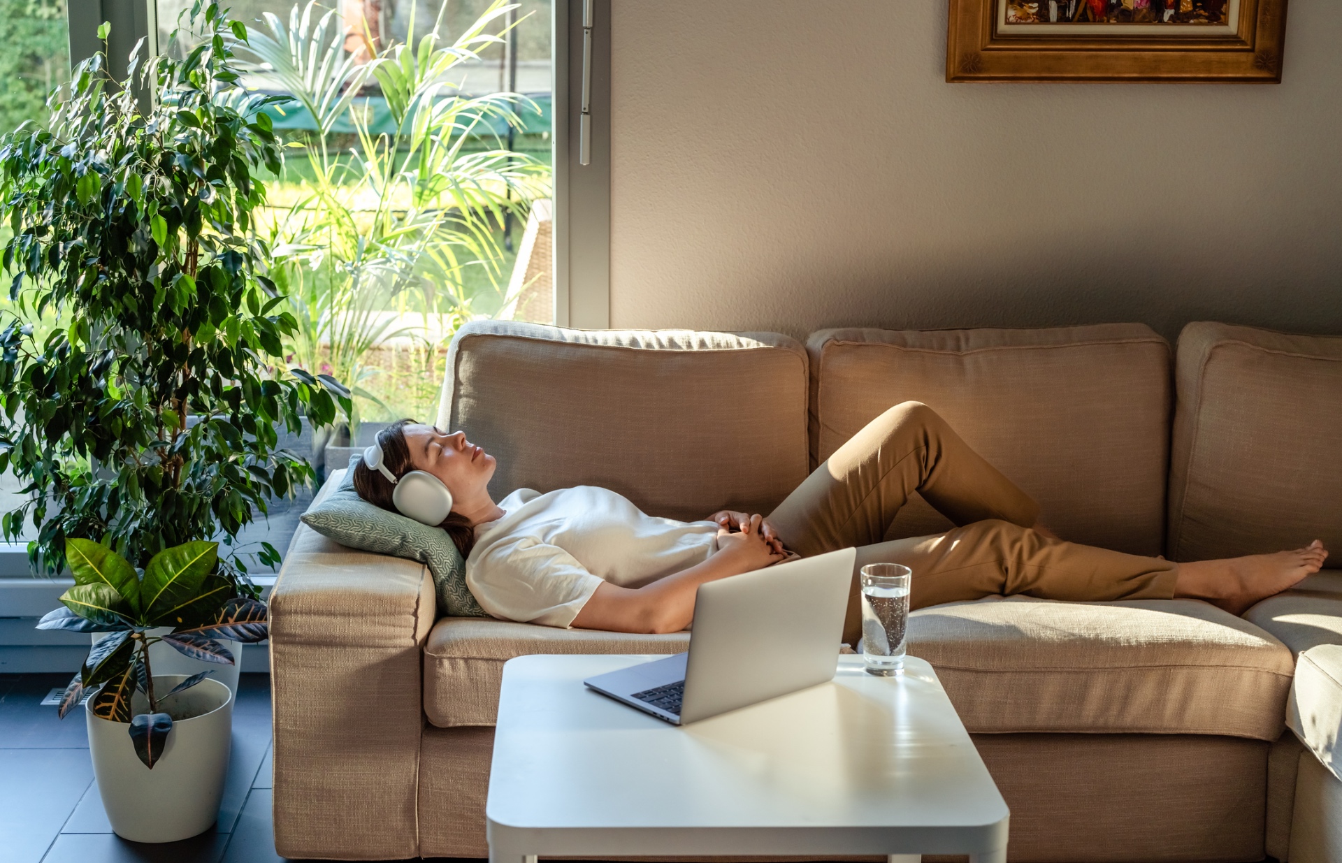 Distance Reiki session from home — resting peacefully on a sofa in sunlit greenery